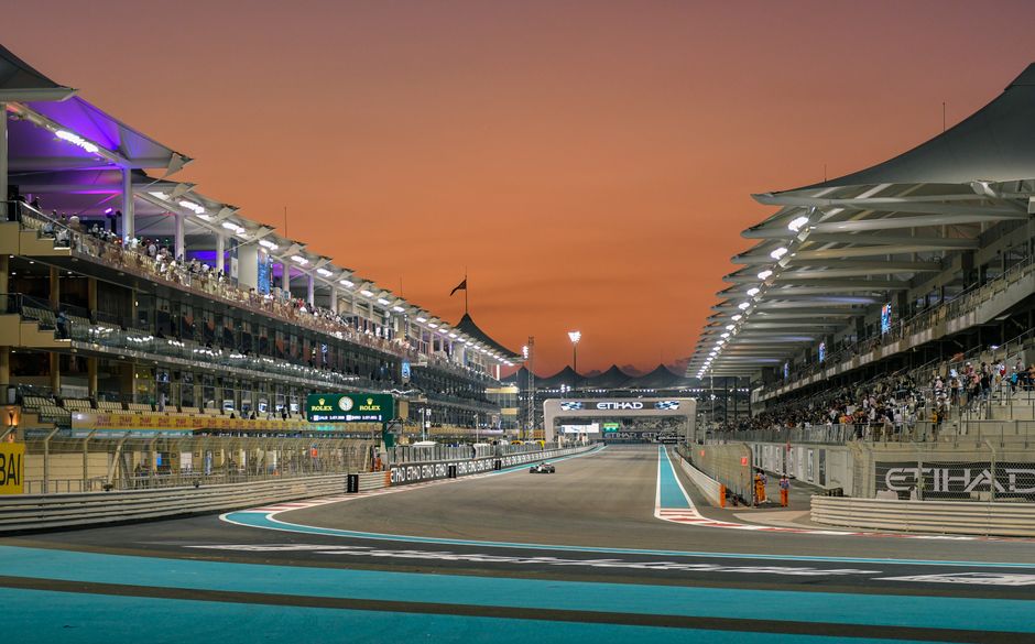 Formula 1 car racing at night during the Abu Dhabi Grand Prix at Yas Marina Circuit